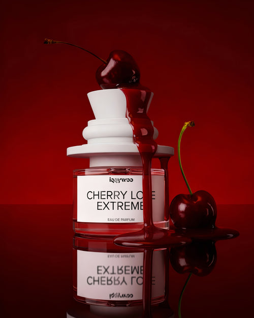 Perfume bottle labeled 'Cherry Love Extreme' with cherries on a red background