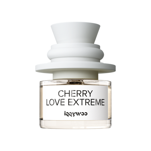 A clear glass bottle fragrance with pale amber liquid, a white label reading 'CHERRY LOVE EXTREME' and 'iggywoo', topped with a sculptural matte white cap on a white background.