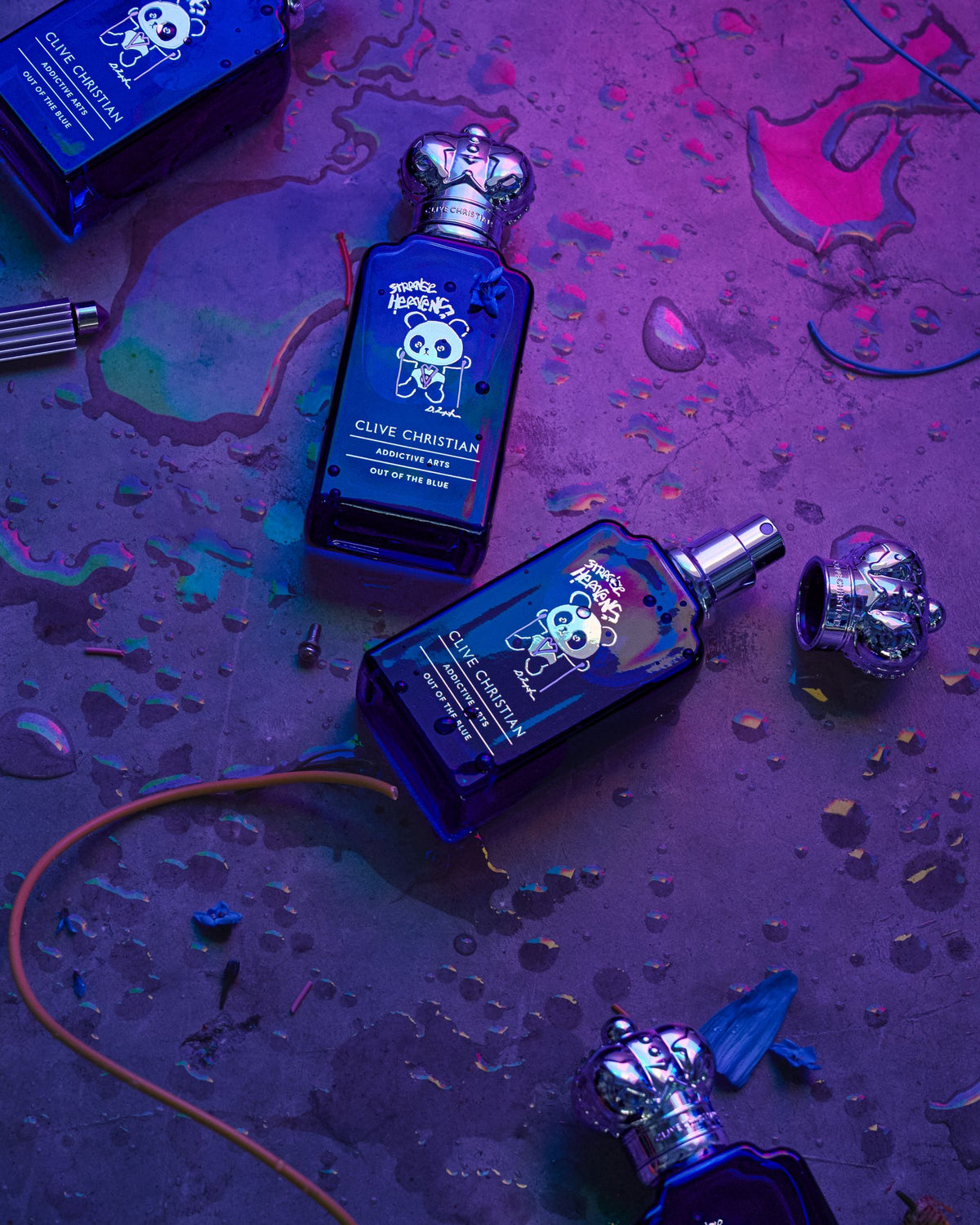 Clive Christian perfume bottles on a textured purple surface
